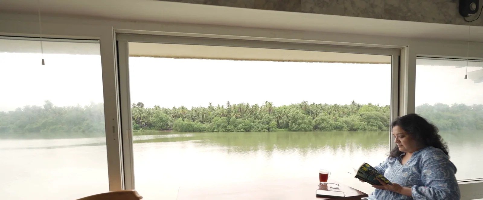 A guest reading by the river window
