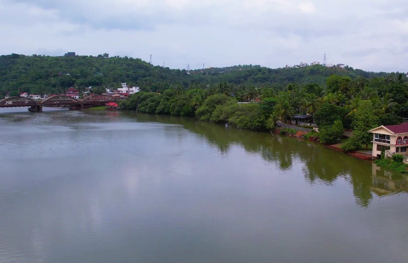 The Kuppam River between green, palm-lined banks